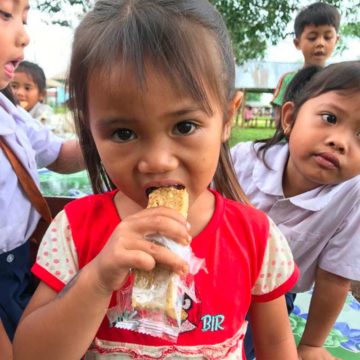 Child eating Snacks4Smiles